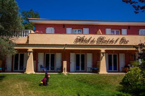 a building with a horse in front of it at Hotel du Pont de l'Oso in Cala Rossa