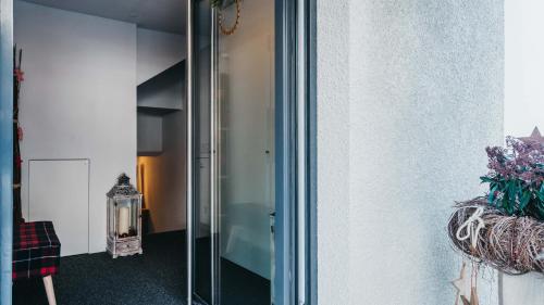 a glass doorway to a room with a stair case at Charming 4 bed flat in Flims in Flims