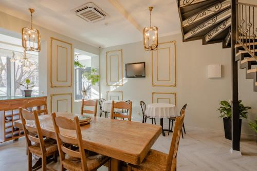 a dining room with a wooden table and chairs at Hotel Day Inn in Tbilisi City