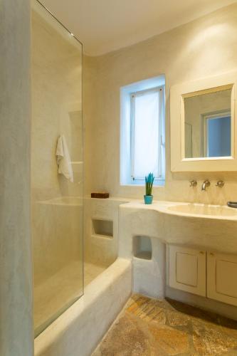 a bathroom with a sink and a shower at Zen Residence in Lia beach in Kalafatis