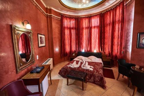 a bedroom with a bed and a table with shoes on it at Exis Hotel in Athens