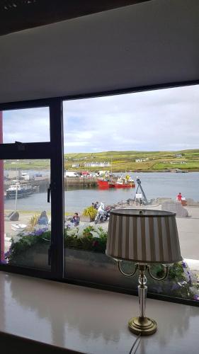a window with a view of a body of water at The Moorings Hotel & Seafood Restaurant in Portmagee