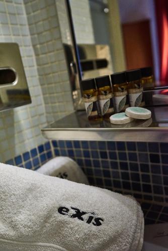 a towel on a sink in a bathroom at Exis Hotel in Athens