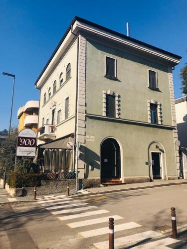 a large white building on the corner of a street at ALBERGO 900Strati in Bergamo