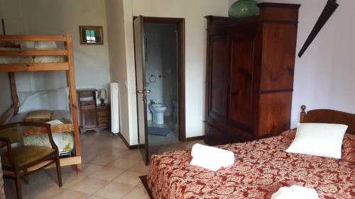 a bedroom with a bed and a chair and a ladder at Biogarden in Zelarino