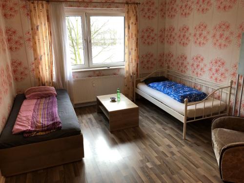 a small room with a bed and a window at Misha,s Place in Duisburg