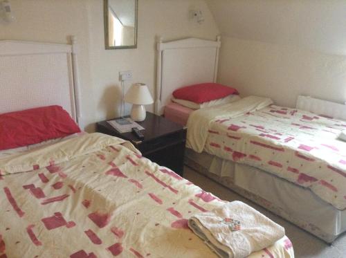 A bed or beds in a room at Park House Guest House 