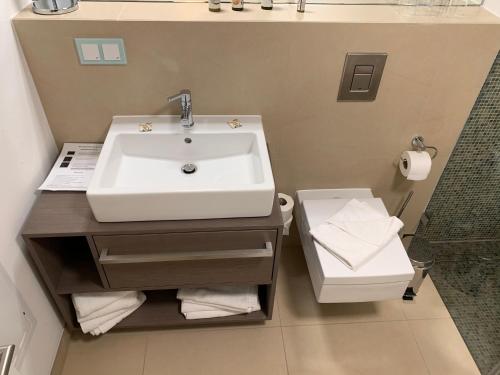 a bathroom with a sink and a toilet at Ostseeblick Rügen in Binz
