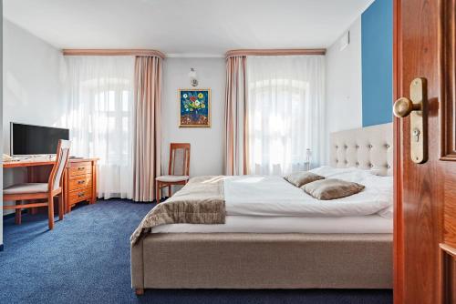 En eller flere senger på et rom på Hotel Młyn Aqua Spa