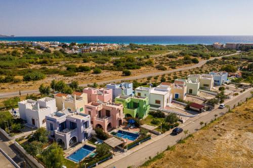 an aerial view of a city with houses and the ocean at 12 Islands Villas in Kolimbia