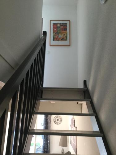 a stairway with a picture on the wall and a picture at ANGLET- BIARRITZ T3 dans résidence avec piscine in Anglet