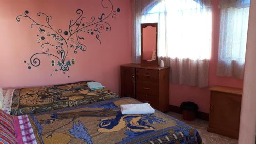 a bedroom with two beds and a mirror at Hospedaje Lolita in San Pedro La Laguna