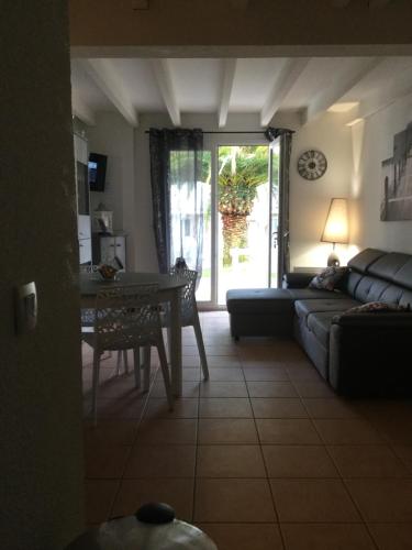 a living room with a couch and a table at ANGLET- BIARRITZ T3 dans résidence avec piscine in Anglet