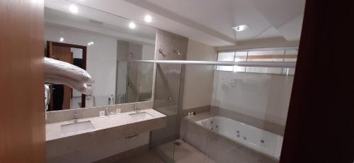 a bathroom with two sinks and a large mirror at Guines Palace Hotel in Patrocínio
