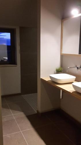 a bathroom with two sinks and a mirror at Ardennature vakantiehuizen met privé-sauna in La Roche-en-Ardenne