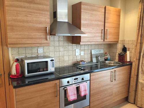 a kitchen with a microwave oven and a sink at Rochester Apartment in London