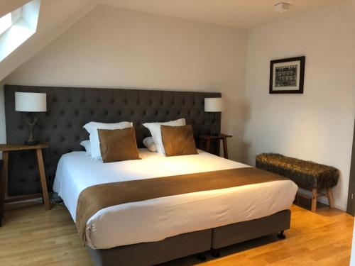 a bedroom with a large bed in a room at L’Auberge de Mézières in Mézières
