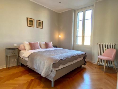 - une chambre avec un lit doté d'oreillers roses et d'une fenêtre dans l'établissement Heart of the Center Superb Flat 50 meters from the sea, à Nice