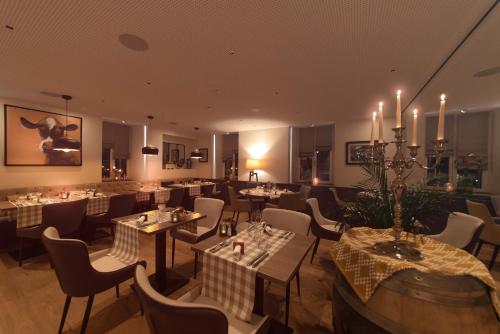 a restaurant with tables and chairs in a room at L’Auberge de Mézières in Mézières