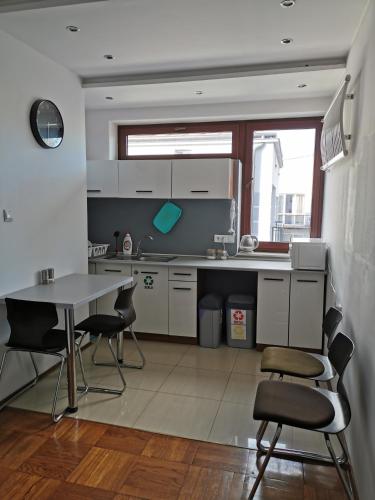 a kitchen with a table and chairs in it at For rest Hostel in Lublin