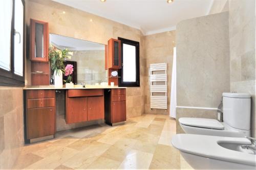 a bathroom with a toilet and a sink and a mirror at C277 Son Rubi by Mallorca Villa Selection in Selva