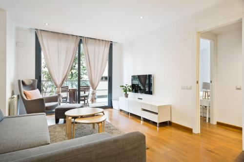 a living room with a couch and a table at Les Corts Exclusive Apartments by Olala Homes in Barcelona