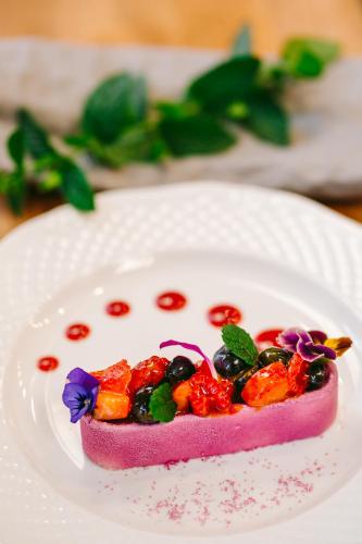 a piece of food on a white plate at Kasztanowy Pałac in Swadzim