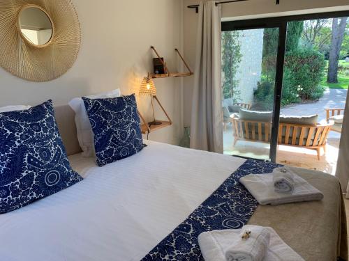 a bedroom with a bed with towels on it at Mas Notre Dame in Eygalières