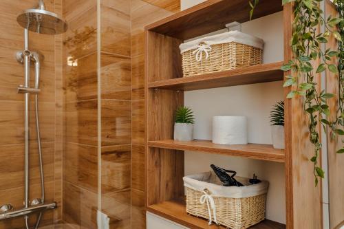 a bathroom with wooden shelves and a shower at Porta del Mare in Kotor