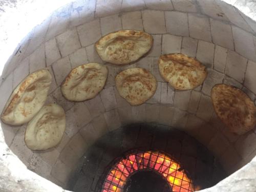 a group of pizzas cooking in an oven at Hotel Lider Complex in Vaykʼ