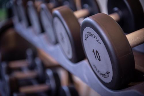 a row of dumbbells hanging in a rack at Gallia Palace Hotel - Relais & Châteaux in Punta Ala
