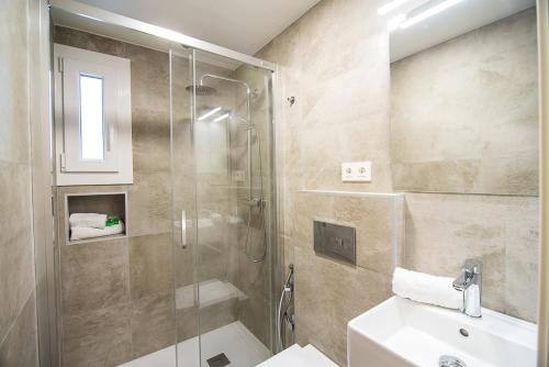 y baño con ducha y lavamanos. en Tourist House Odonell, en Sevilla