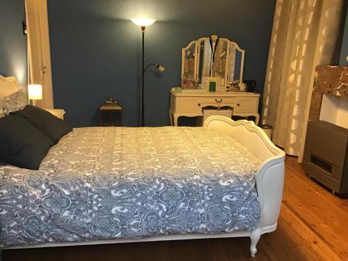 a bedroom with a bed and a dresser and a mirror at Room Feliz in Zele