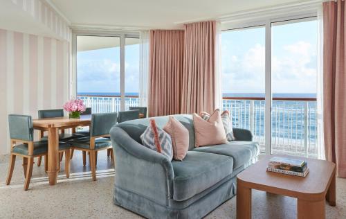 a living room filled with furniture and a large window at Four Seasons Resort Palm Beach in Palm Beach