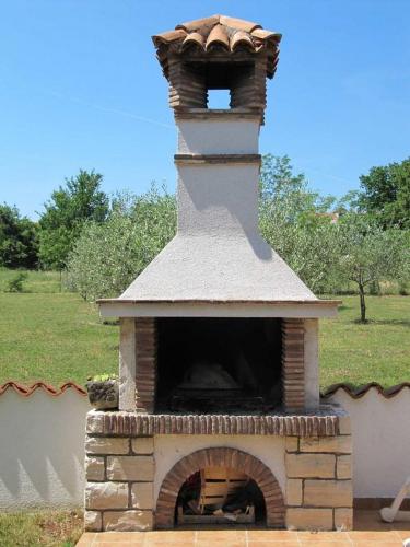 a brick oven with a tower on top of it at Villa "Pied-à-terre" Residence & Spa in Umag