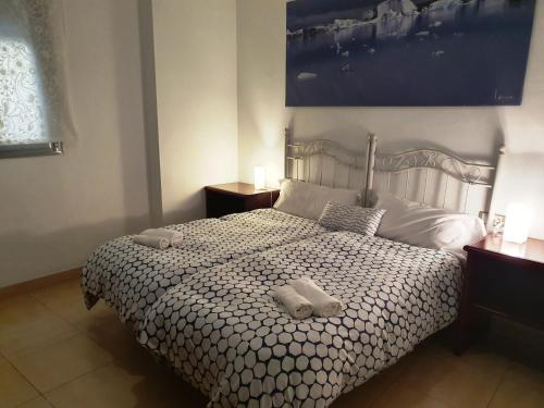 Cama o camas de una habitación en Apartamentos Turísticos La Encarnación