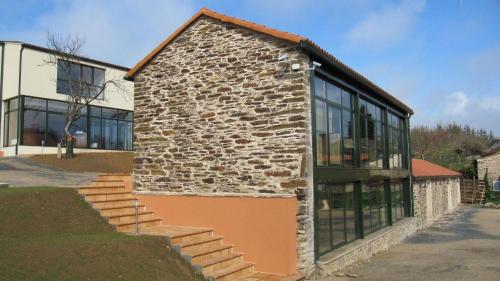 a stone building with a bunch of windows at Hotel Amenal in Amenal