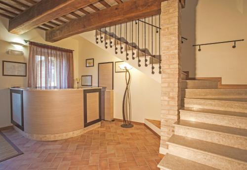a lobby with a staircase in a house at Il Ristoro Del Viandante in Offagna