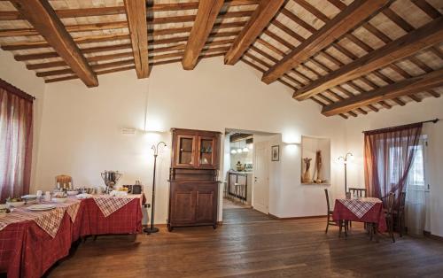 a dining room with two tables and a room with a ceiling at Il Ristoro Del Viandante in Offagna