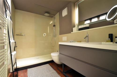 a bathroom with a sink and a toilet and a mirror at Luxury Omaruru-Design-Apartment Deluxe in Munich