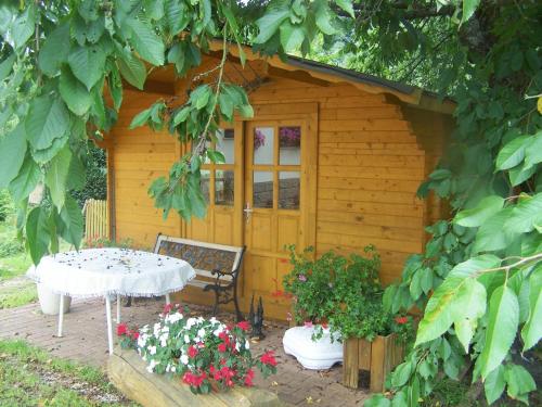 a small wooden cabin with a table in front of it at Hotel-Restaurant Laux in Merzig