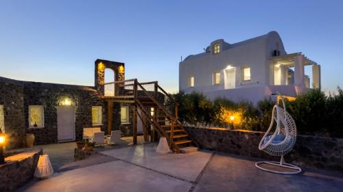 a house with a staircase in front of it at Sakas Residences in Karterados