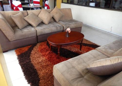 a living room with a couch and a coffee table at La Merced Plaza Hospedaje in Riobamba