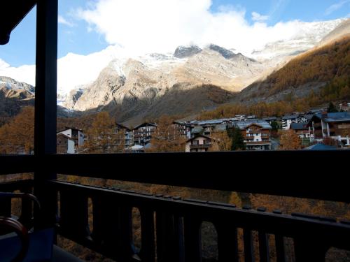 a view of a mountain range from a balcony at Ambiente Guesthouse in Saas-Fee