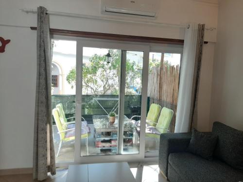 a living room with a sliding glass door at Beach Falésia in Albufeira