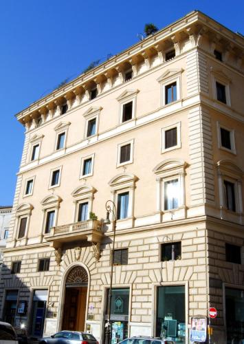 a large stone building on a city street at Hotel Primavera in Rome