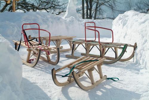 a picnic table and two chairs in the snow at Märchenhotel in Braunwald