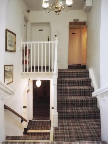 a set of stairs in a house with a stair case at Bower House Inn in Eskdale