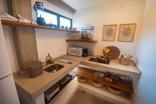 a kitchen with a sink and a counter top at Aldeia do Mar Sensorial Hotel in Itacaré