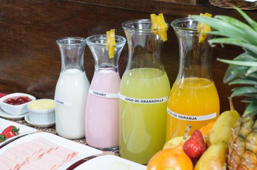 four bottles of different types of juice and fruit at Posada San Blas in Cusco